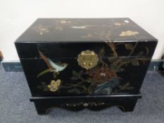 A black lacquered Japanese style storage box on stand,