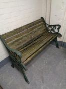 A cast iron wooden slatted garden bench