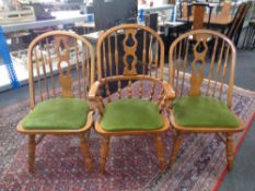 A set of six American style wheel back dining chairs comprising of two carvers and four singles