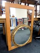 A circular gilt framed bevelled mirror together with a further contemporary beech framed mirror