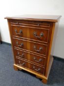 A yew wood single door cabinet with faux drawers in front