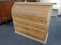 A 19th century continental pine barrel fronted bureau fitted four drawers beneath
