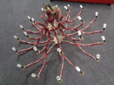 A contemporary red glass eight branch chandelier with twenty four lights