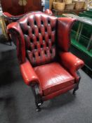 A Chesterfield red button leather wingback armchair (a/f) CONDITION REPORT: Backrest