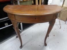 A 19th century oak demi-lune hall table fitted a drawer