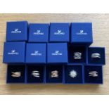 Seven Swarovski crystal dress rings in retail boxes.