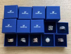 Seven Swarovski crystal dress rings in retail boxes.