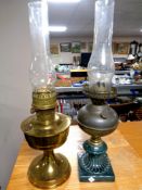 An Aladdin brass oil lamp with chimney together with a further oil lamp with ceramic base with