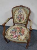 A French style carved beech salon armchair upholstered in tapestry fabric
