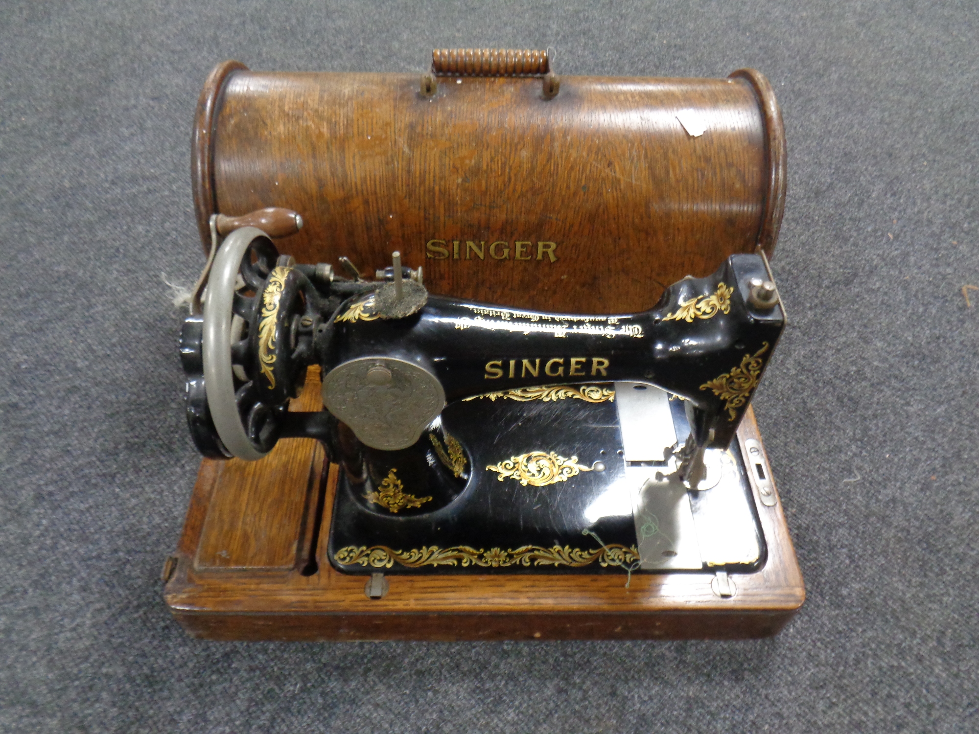 A vintage Singer hand sewing machine in case