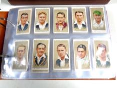 An album of Players and Wills cigarette cards, flags,