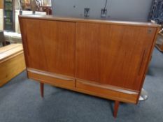 A mid 20th century Danish teak sliding double door sideboard fitted two drawers beneath,