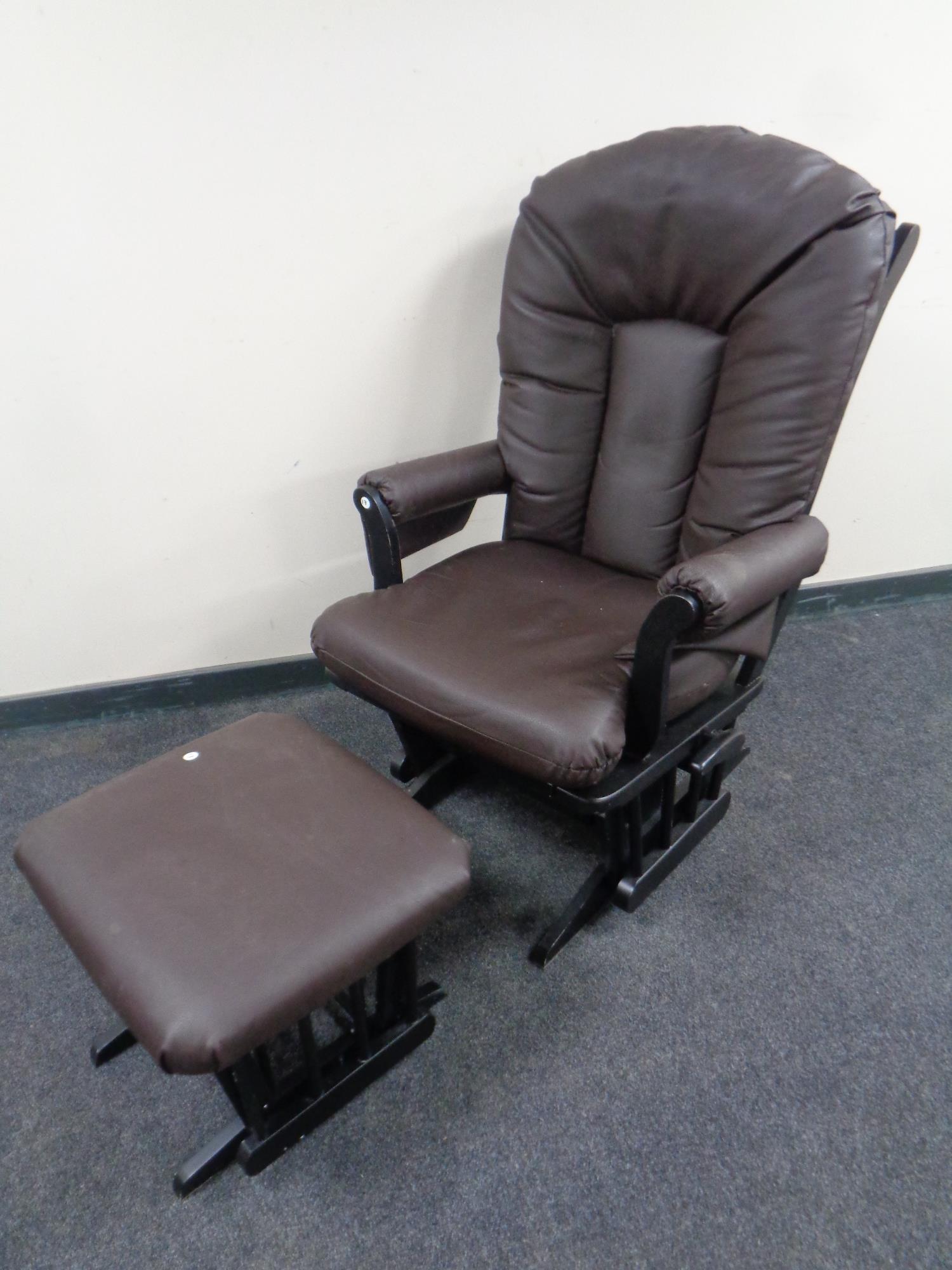 An Easy Glide armchair and footstool in brown vinyl