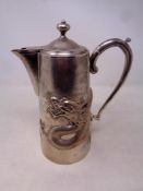 A Chinese silver coffee pot, embossed with dragon decoration, height 22.