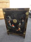 A Japanese style black lacquered cabinet with brass fittings