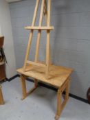 A pine adjustable draughtsman's table together with a folding easel