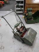 A vintage Atco petrol lawn mower with grass box and roller