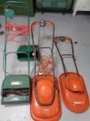 A Qualcast electric lawn mower with grass box together with two further Flymo mowers,