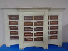 Three painted wall mounted residency boards bearing names