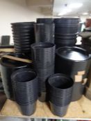 A large quantity of plastic garden plant pots and stands