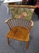 A mid 20th century beech wood stick back armchair