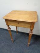 An antique pine work table on raised legs