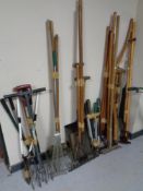 Approximately seven bundles of garden tools, shovels, spades, forks, rakes,