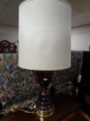 A brass and wooden table lamp with shade