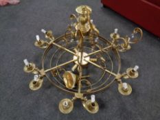 A contemporary brass effect circular chandelier with twelve lights and cut glass drops