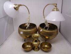 Two Eastern brass planters on raised feet, two brass tea bowls,