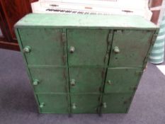 An early 20th century painted nine door industrial cabinet