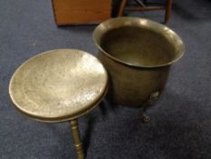 An antique brass planter on lion paw feet together with an eastern brass tripod stool