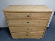 An antique stripped pine four drawer chest