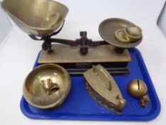 A tray of vintage set of pan scales with weights, brass ware - money box, flat iron,