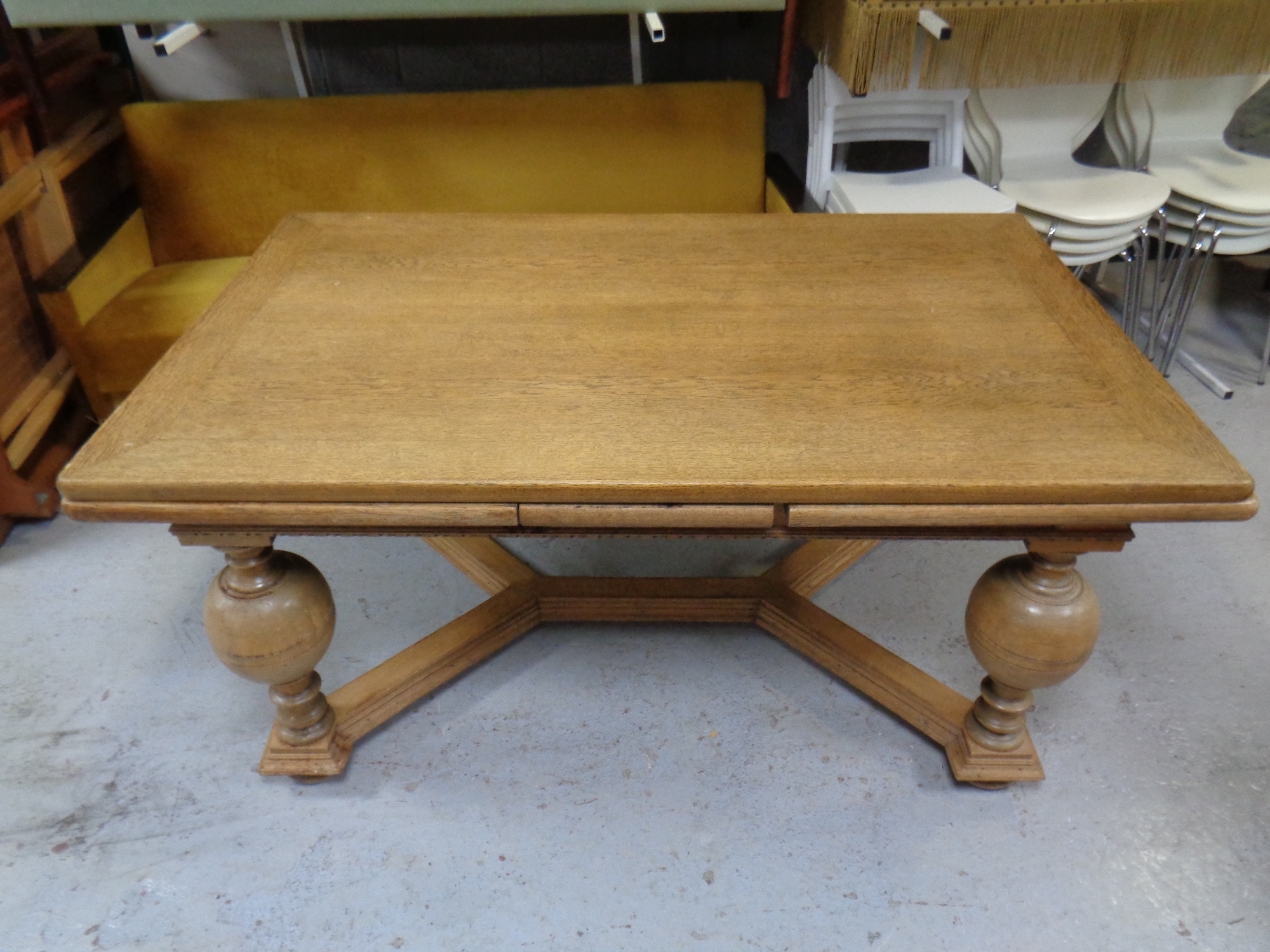 An antique oak extending dining table on bulbous legs