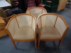A set of three wood framed bergere backed tub chairs
