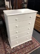 A contemporary white five drawer chest