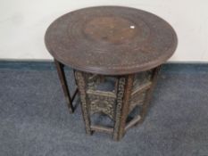 A circular carved Indian occasional table (as found)