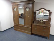 An Edwardian Arts & Crafts mirrored double door wardrobe fitted two drawers and a matching two