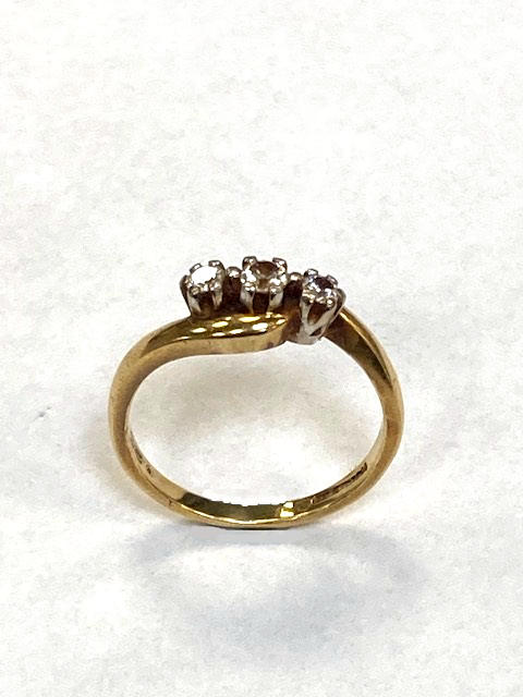 A yellow gold ring set with three diamonds