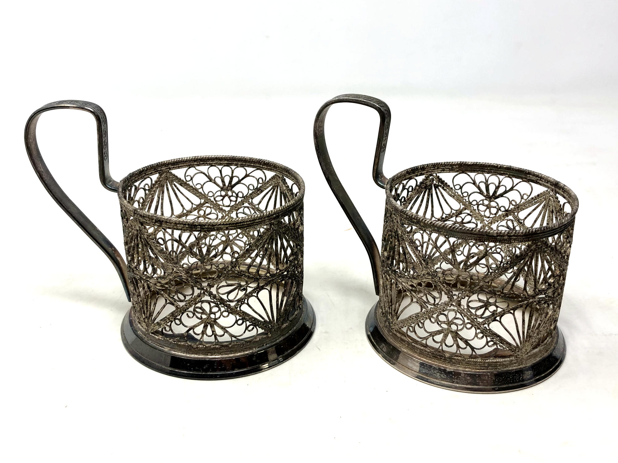 Two Russian white metal cup holders marked Hommet