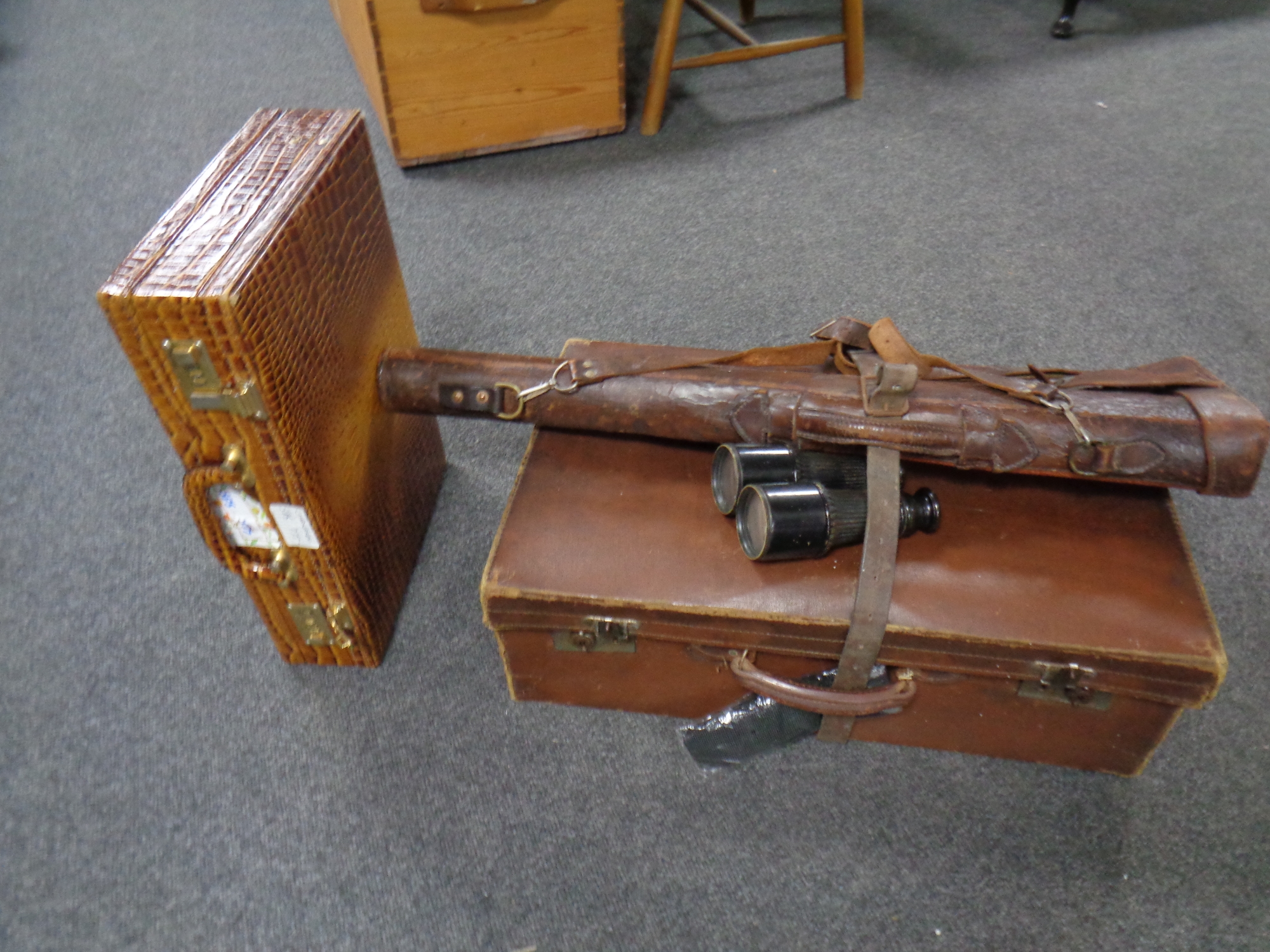 A faux crocodile skin briefcase together with a luggage case,