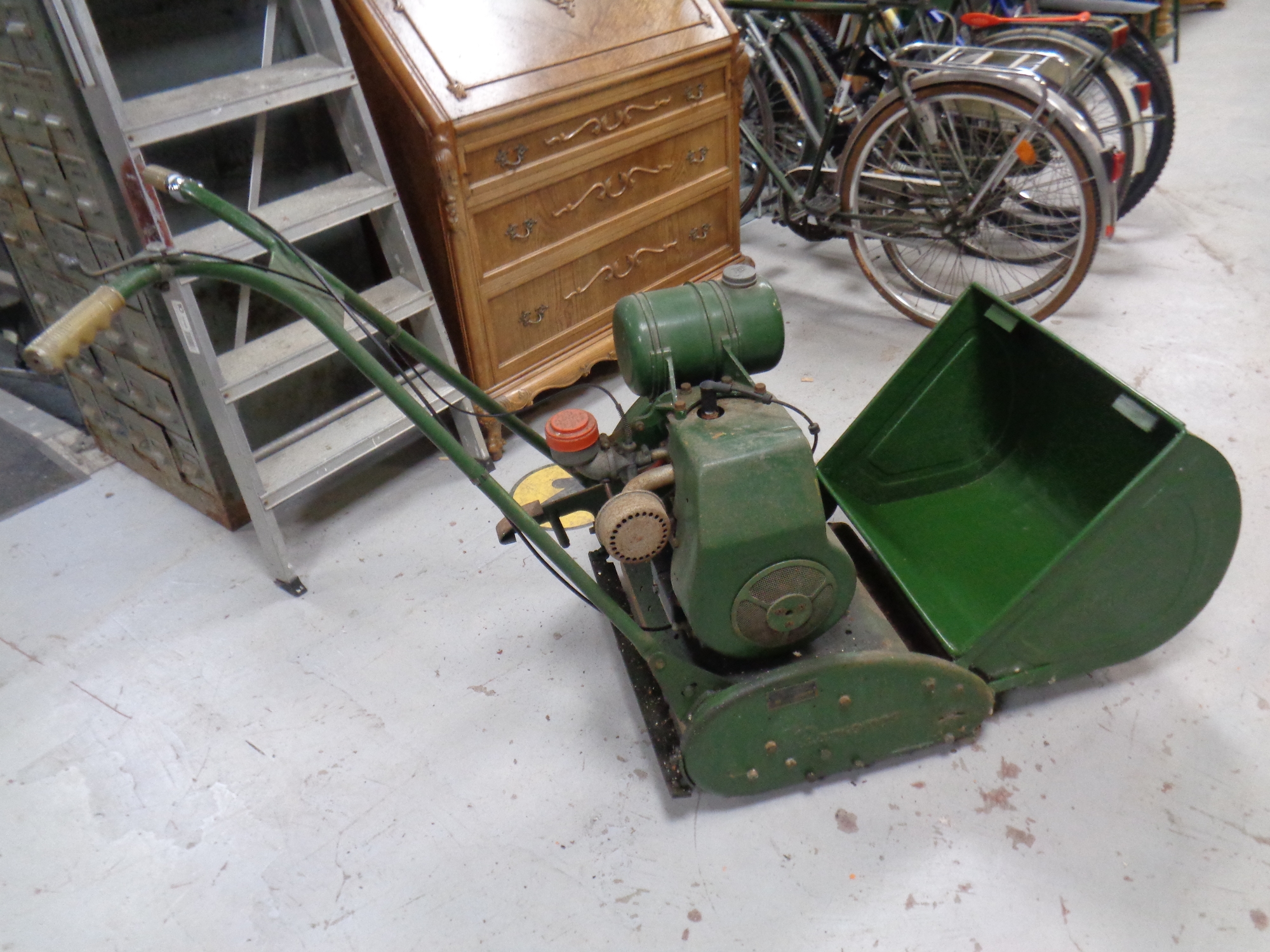 A vintage Ransomes model 3 Meteor 4 petrol lawn mower with grass box