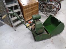 A vintage Ransomes model 3 Meteor 4 petrol lawn mower with grass box