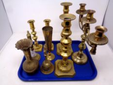 A tray of antique and later brass ware, two pairs of candlesticks, three way table candelabra,