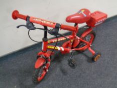 A toddler's fire chief rescue bike with stabilisers