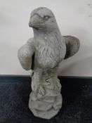 A concrete garden statue of an eagle