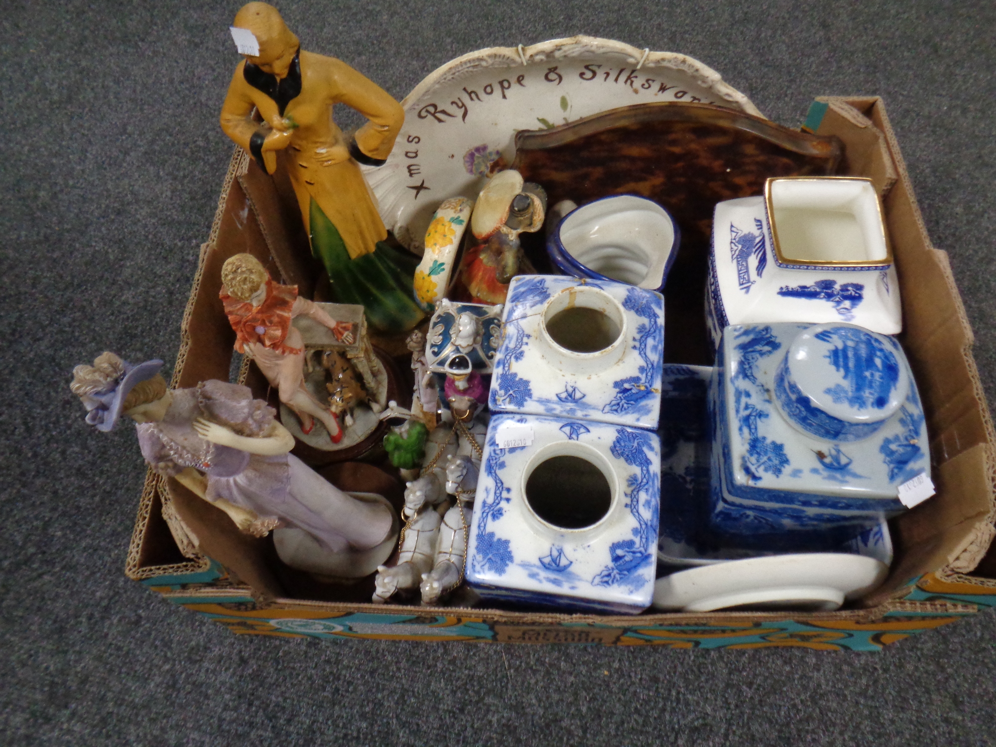 A box of assorted ceramics - Art Deco style figures, Ringtons caddies,