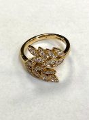 An 18ct gold diamond leaf design ring, size L/M.