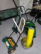 A quantity of garden tools including push mower, seed spreader, aluminium bucket,